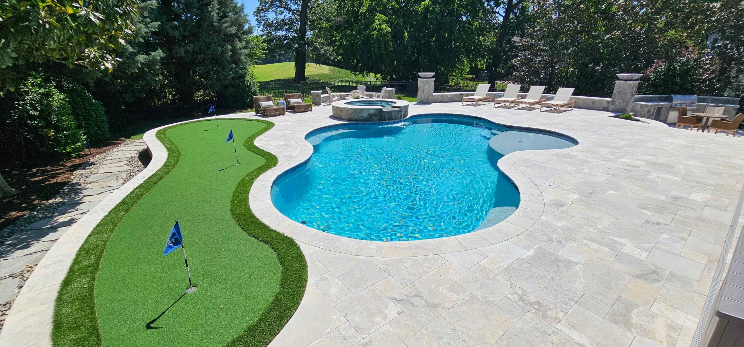 Putting green beside of new swimming pool and spa